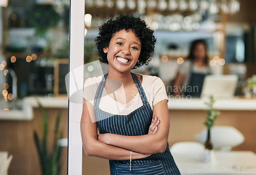 Image of Happy woman, portrait and arms crossed at cafe in small business or waitress at entrance. Confident African female person, barista or restaurant smiling in confidence for management at coffee shop