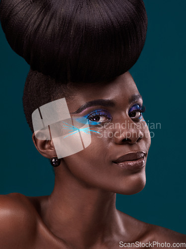 Image of Portrait, haircare and makeup with a model black woman in studio on a blue background for beauty. Face, hair and cosmetics with an attractive young female person at the salon for fashion or styling