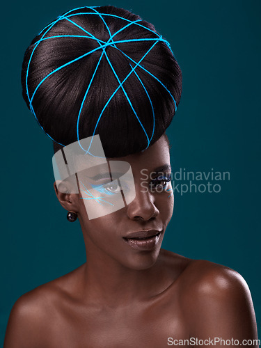 Image of Portrait, hair and fashion with a model black woman in studio on a blue background for beauty. Face, haircare and cosmetics with an attractive young female person at the salon for makeup or styling