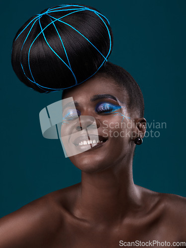 Image of Happy, hair and makeup with a model black woman in studio on a blue background for beauty. Smile, haircare and cosmetics with an attractive young female person at the salon for fashion or styling