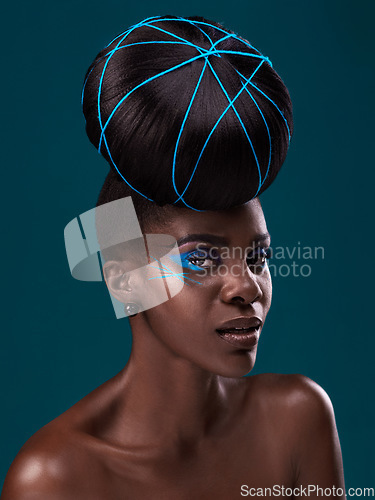 Image of Portrait, fashion and hair care with a model black woman in studio on a blue background for beauty. Face, beauty and cosmetics with an attractive young female person at a salon for contemporary style