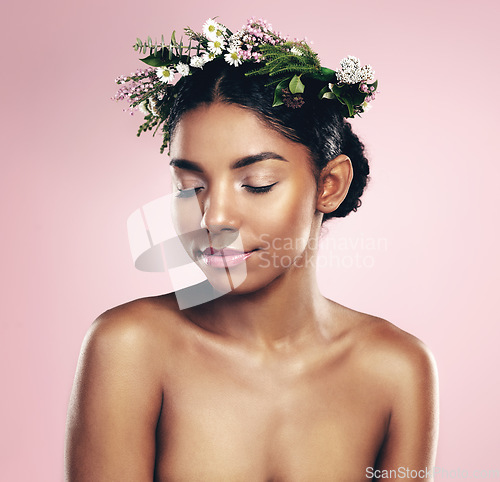 Image of Woman, flowers and crown for beauty in studio, pink background and natural skincare. African face, female model and floral headband of spring plants, sustainable cosmetics and eco friendly makeup