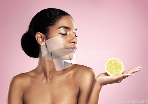 Image of Lemon, natural beauty and woman in studio, pink background and mockup of nutrition. African model, healthy skincare and citrus fruit of sustainable cosmetics, vegan dermatology and vitamin c benefits