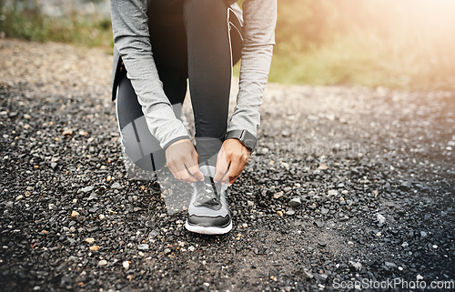 Image of Closeup, fitness and woman outdoor, tie shoes and cardio workout for training, run and exercise. Zoom, female person or athlete start with practice, hands and runner outside for a marathon and sports