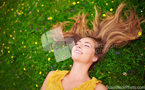 Image of Top view, relax or woman on grass, flowers or freedom with happiness, care or healthy. Female person, natural or happy lady with a smile, carefree or wellness outdoor, nature or spring time with hair