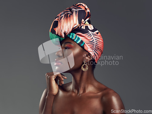 Image of Makeup, turban and profile of a black woman in a studio with classy, elegant and traditional accessories. Beauty, cosmetic and young African female model with a head wrap isolated by gray background.