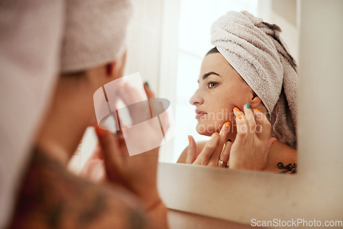 Image of Beauty, acne and woman cleaning her face for skincare morning routine in her bathroom in a home or house. Facial, pimple and female person doing cosmetic self love or care in her house mirror