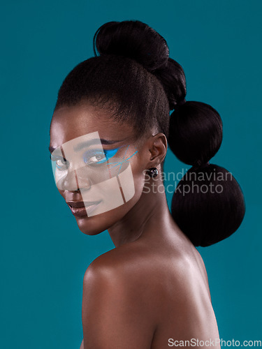 Image of Portrait, beauty and makeup with a model black woman in studio on a blue background for hair or fashion. Face, cosmetics and haircare with an attractive young female person posing for haircare