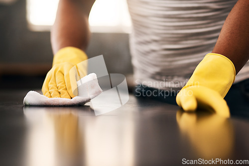 Image of Man hands, cleaning gloves and wipe on a table with a wash cloth and housekeeping. Home, countertop and male person with disinfectant and scrub with washing in a apartment with maid and housekeeper