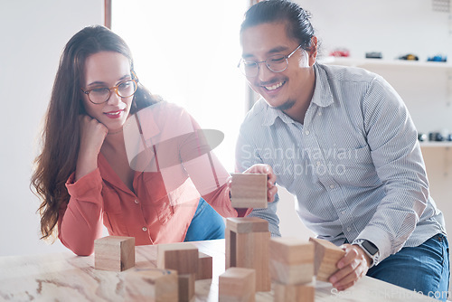 Image of Teamwork, man and woman with building blocks in startup office for challenge game and design innovation with vision. Engineering, architecture and designer team with block games for problem solving