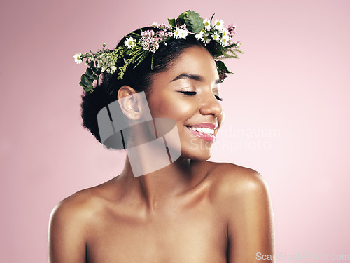 Image of Happy woman, flower crown in hair for beauty in studio, pink background and natural skincare. African face, female model and floral headband of plants, sustainable cosmetics and eco friendly fashion