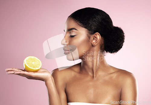 Image of Lemon fruit, beauty and woman in studio, pink background and mockup of healthy nutrition. African model, natural skincare and citrus of sustainable cosmetics, vegan dermatology and vitamin c benefits