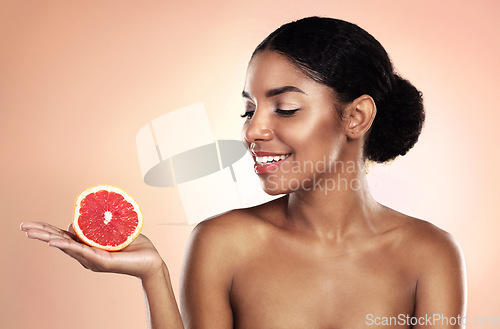 Image of Grapefruit, natural beauty and happy woman in studio, background and sustainable mockup. African model, healthy skincare and citrus fruits for cosmetics, organic dermatology and vitamin c benefits