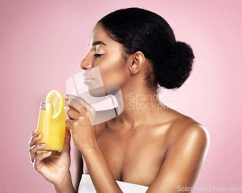 Image of Face of woman, orange juice and drink in studio, pink background and detox for healthy skincare. African model, citrus smoothie and vitamin c fruits for nutrition benefits, natural beauty or wellness