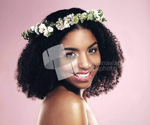 Image of Happy woman, portrait and flower crown for beauty in studio, pink background and natural skincare. Face of african model, floral wreath and plants for sustainable cosmetics, hair care and dermatology
