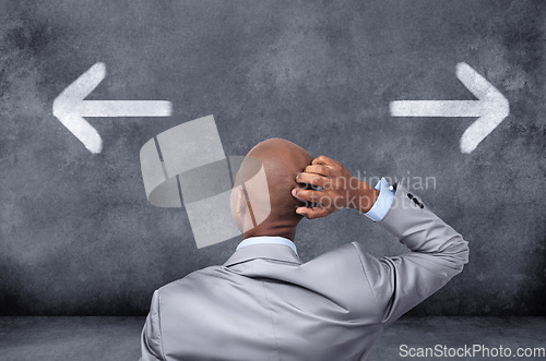 Image of Business, chalkboard and black man with a decision, arrows and choices for career development, opportunity and confusion. Male employee, consultant or entrepreneur with symbol and icons for direction