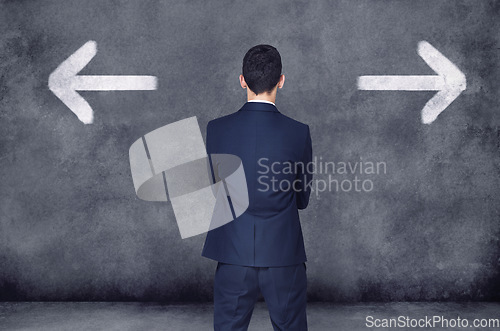 Image of Back, business and man with decision, opportunity and choice with startup, arrows and chalkboard. Male person, employee and entrepreneur with ideas, confused and consultant with formal wear or a suit