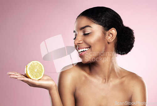 Image of Lemon, healthy beauty and happy woman in studio mockup, pink background and smile for vitamin c benefits. African model, citrus fruits and natural skincare for cosmetics, vegan dermatology and detox