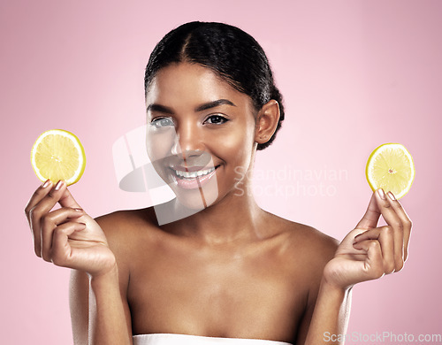 Image of Portrait of happy woman, lemon and skincare in studio, pink background or wellness of vitamin c benefits. Face of african model, citrus fruits and nutrition of beauty, organic cosmetics or detox diet