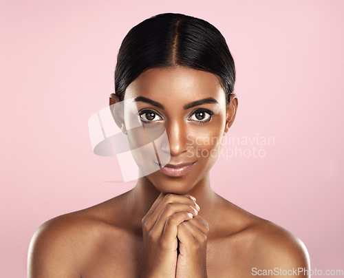 Image of Face portrait, skincare and woman in studio isolated on a pink background. Natural beauty, aesthetic and Indian female model with makeup, cosmetics and spa facial treatment for healthy skin glow.