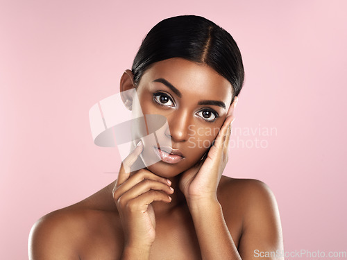 Image of Serious face, skincare and woman in studio isolated on a pink background. Natural beauty, portrait and Indian female model with makeup, cosmetics and spa facial treatment for healthy skin aesthetic.