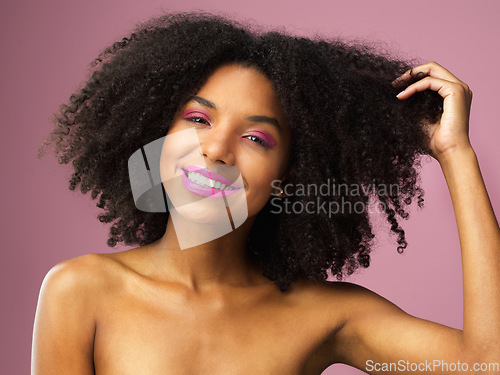 Image of Face, hair care and smile of black woman with afro in studio isolated on pink background with eyeshadow. Hairstyle portrait, lipstick makeup or African female model with salon treatment for cosmetics