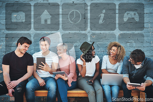 Image of Technology, diversity and group of young people on a bench browsing social media or the internet. Digital tablets, laptop and multiracial friends networking online together with icons by a gray wall.