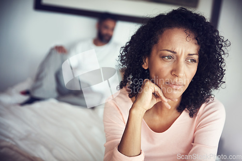 Image of Angry, sad and couple in bedroom for problem, divorce decision and marriage fail or mental health risk. Depression, fight and african woman thinking with partner at home depressed, anxiety or stress