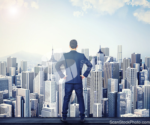 Image of Back, view of the city and a business man standing hands on hips outdoor with a vision or mindset of success. Proud sky and buildings with a male corporate employee looking out over an urban town