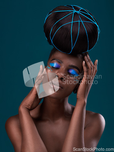 Image of Face, hair and makeup with a model black woman in studio on a blue background for beauty. Hands, haircare and cosmetics with an attractive young female person at the salon for fashion or styling