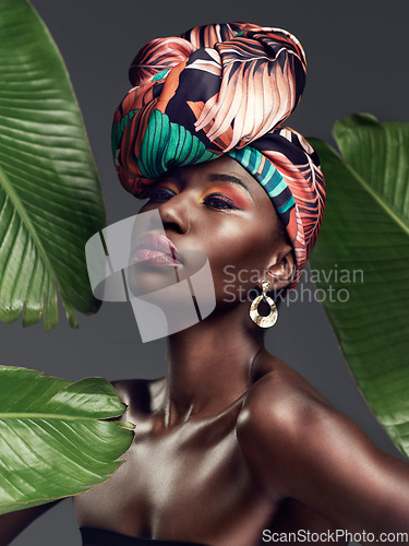 Image of Black woman in traditional turban, fashion with leaves and beauty with makeup on studio background. Natural cosmetics, nature aesthetic and female model with African head wrap, creativity and style