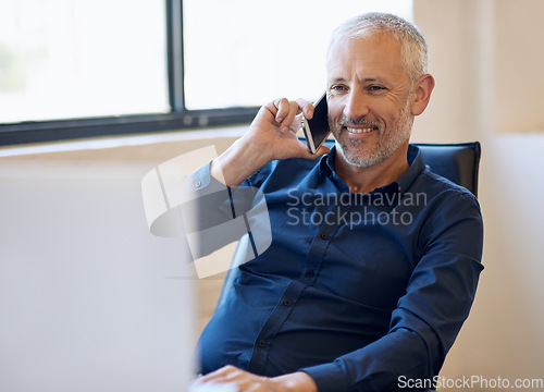 Image of Business, senior businessman on phone call and computer at desk in office. Corporate, social networking or communication with smartphone and mature man on cellphone talking on phone with pc at work