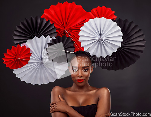 Image of Origami fans, portrait and a black woman for culture isolated on a black background in a studio. Paper, creative and an African model with art design for tradition, color and Japanese celebration