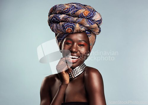 Image of Happy black woman in African turban, fashion and beauty with makeup isolated on studio background. Natural cosmetics, smile in portrait and female model in traditional head wrap, playful and style
