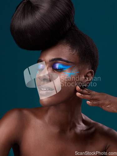 Image of Face, makeup and hair with an african woman model in studio on a blue background for cosmetics or haircare. Beauty, eyeshadow and haircare with an attractive young female person posing eyes closed
