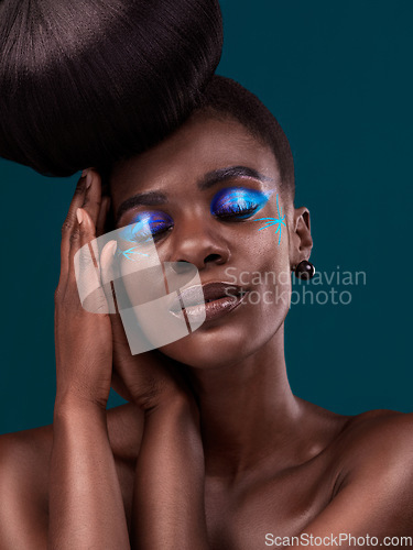 Image of Face, beauty and cosmetics with an african woman in studio on a blue background for hair or cosmetics. Eyes closed, haircare and fashion with an attractive young female model at the salon for style