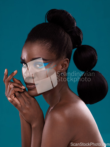 Image of Portrait, beauty and cosmetics with a model black woman in studio on a blue background for hair or fashion. Face, makeup and haircare with an attractive young female person posing for haircare