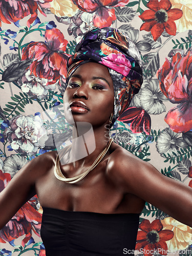 Image of Black woman in portrait in turban, fashion on flower background and beauty, makeup and floral aesthetic. Natural cosmetics, female model in traditional African head wrap with creativity and style