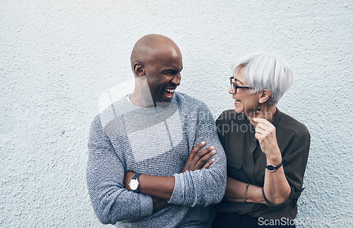 Image of Senior, creative and professional with wall in white background talk about collaboration for business. Employee, conversation and outdoor about teamwork with smile for working on startup as career.