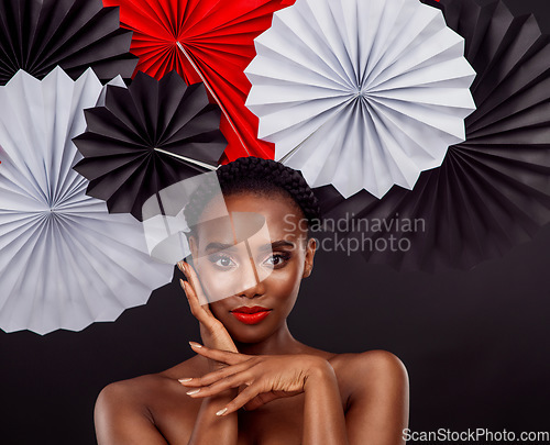 Image of Origami fans, portrait and a black woman with art for culture isolated on a black background. Creative, makeup and an African model with Japanese traditional art, paper or craft on a studio backdrop