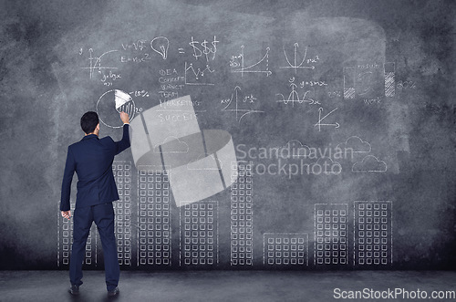 Image of Businessman, numbers and chalkboard for finance in background is thinking of investment with graph. Professional person, planning and writing about future of company with idea to invest for profit.