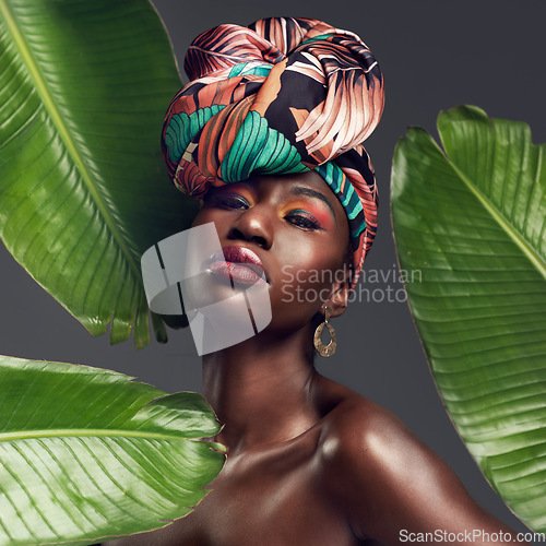 Image of Leaf, makeup and portrait of black woman in studio for glow or natural cosmetics on grey background. Culture, beauty and face of African lady model with plant for cosmetology and jungle aesthetic