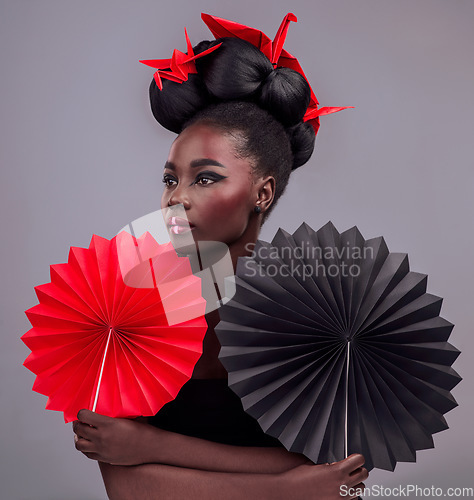 Image of Beauty, cosmetics and origami with black woman in studio for creative, art and culture. Traditional, makeup and paper design with female model and fans on grey background for asian, retro or color