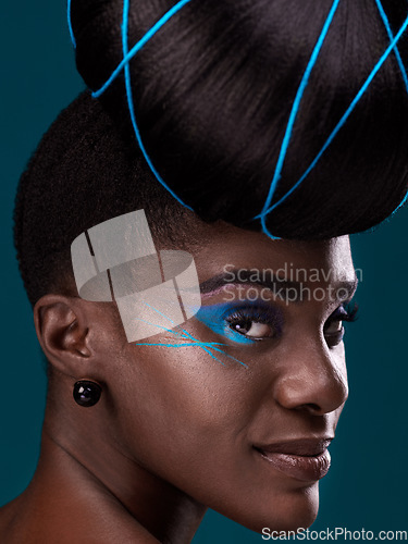 Image of Portrait, hair and makeup with a black woman closeup in studio on a blue background for beauty. Face, haircare and cosmetics with an attractive young female model at the salon for fashion or styling