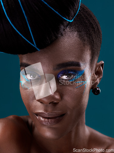 Image of Portrait, makeup and eye shadow with a black woman in studio on a blue background for beauty. Face, hair and cosmetics with an attractive young female model at the salon for fashion or styling