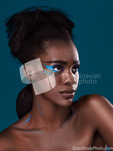 Image of Thinking, natural hair and makeup with a black woman in studio on a blue background for beauty. Idea, haircare and cosmetics with an attractive young female model at the salon for fashion or styling