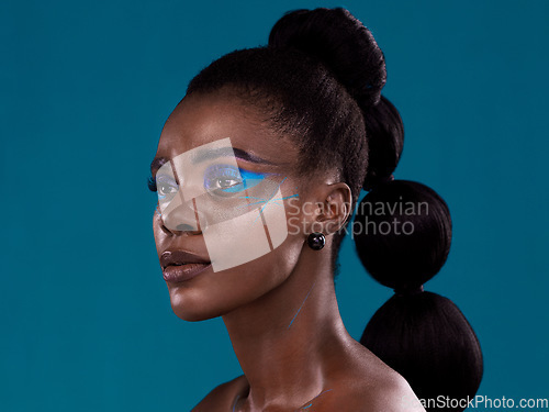 Image of Idea, makeup and cosmetic with a model black woman in studio on a blue background for hair or beauty. Face, thinking and fashion with an attractive young female person posing to promote cosmetics