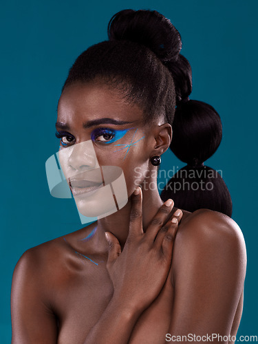 Image of Portrait, makeup and hair care with an african woman in studio on a blue background for hairstyle or cosmetics. Face, haircare and fashion with an attractive young female model posing for beauty