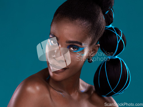 Image of Portrait, beauty and makeup with an african woman in studio on a blue background for hair or cosmetics. Face, haircare and fashion with an attractive young female model at the salon for style