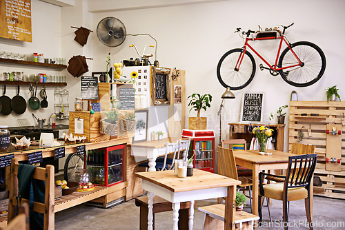 Image of Space, interior and empty coffee shop with table, chairs and furniture or small business, bistro and cafe with unique design and style. Background, creative startup and food store with bike on wall